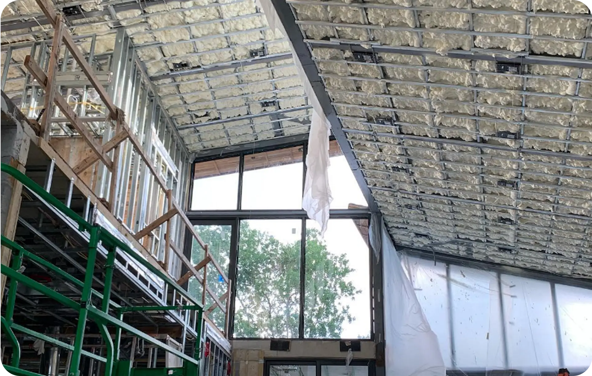 Closed-cell spray foam insulation installed in commercial ceiling with metal stud framing in South Florida
