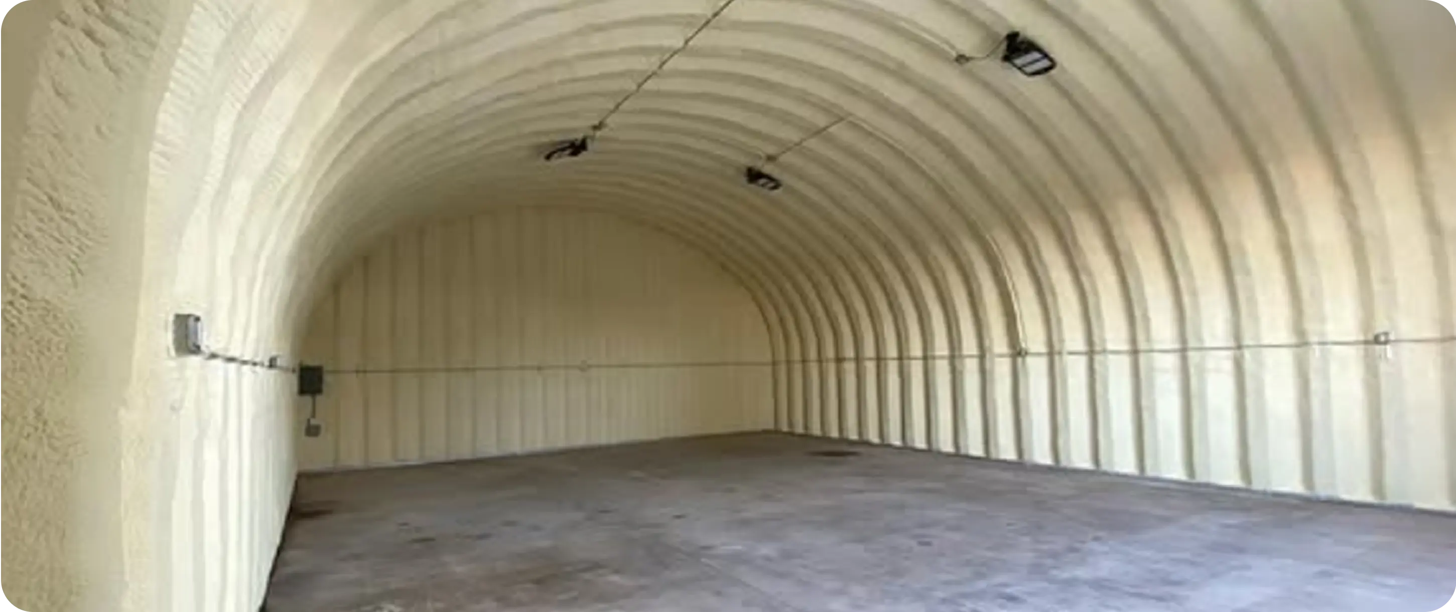 Same metal building after closed-cell spray foam insulation — full coverage on walls and ceiling