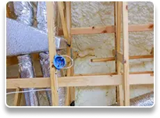 Closed-cell spray foam insulation applied to wall cavity